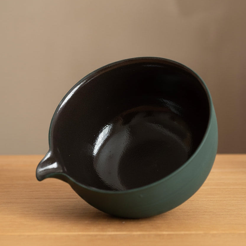 Looking into the chawan, the dark glossy glaze inside and the pouring spout at the left