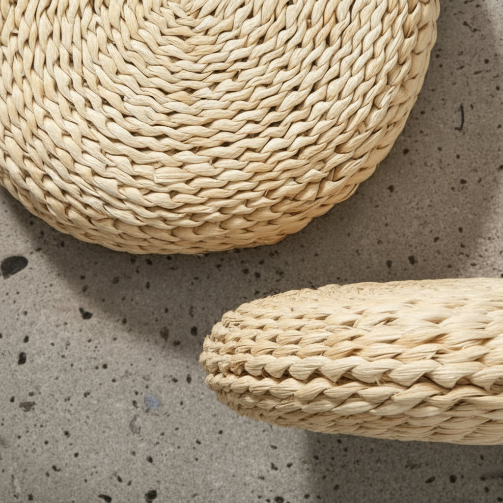 Close on the braiding of two cushions, the twisted cattail laid in tight rows