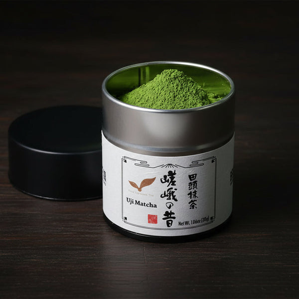 A tin of Uji matcha, open, the powder mounded inside.The label reads Uji Matcha, Saga no Mukashi, 1.06 oz