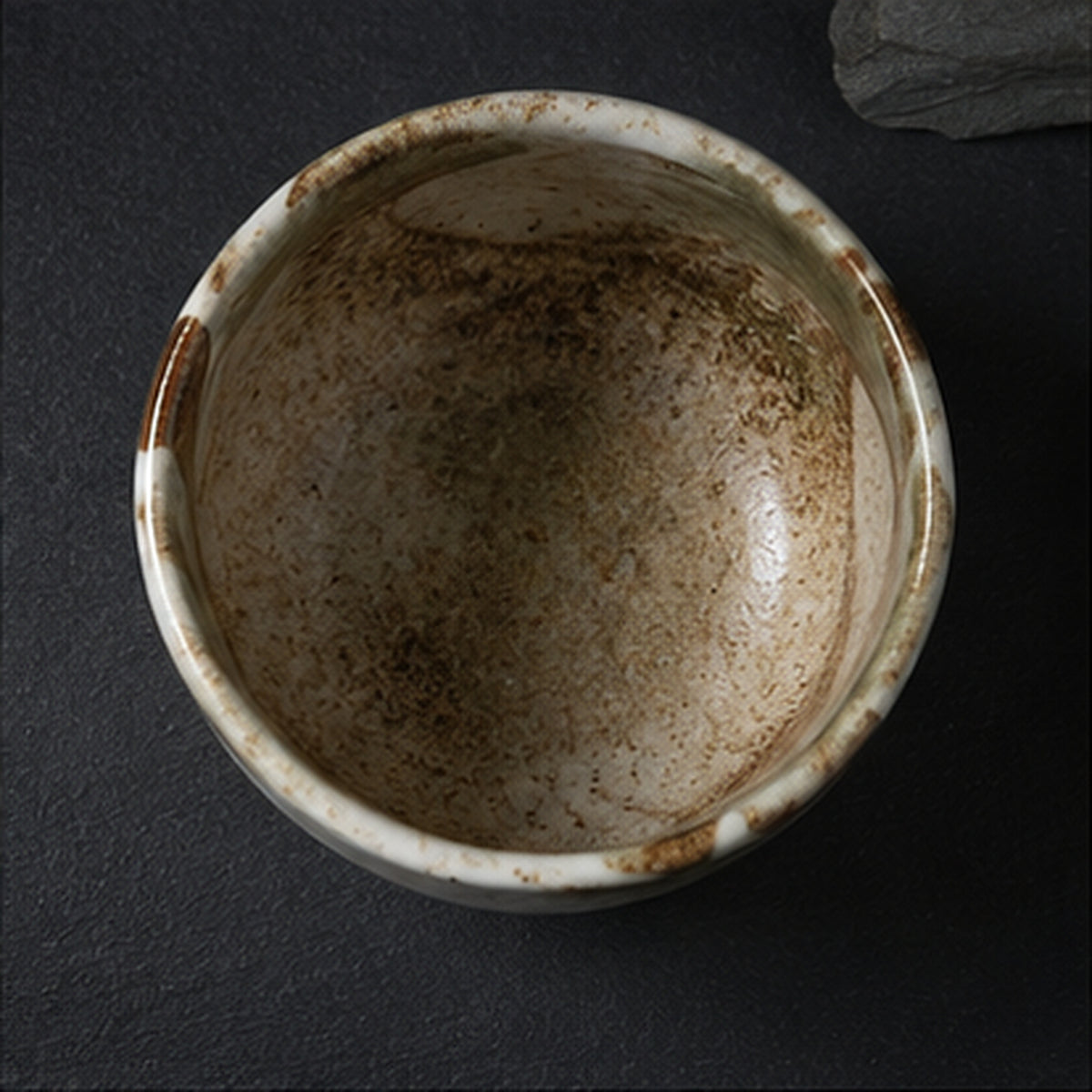 Looking down into the bowl, the interior speckled with iron